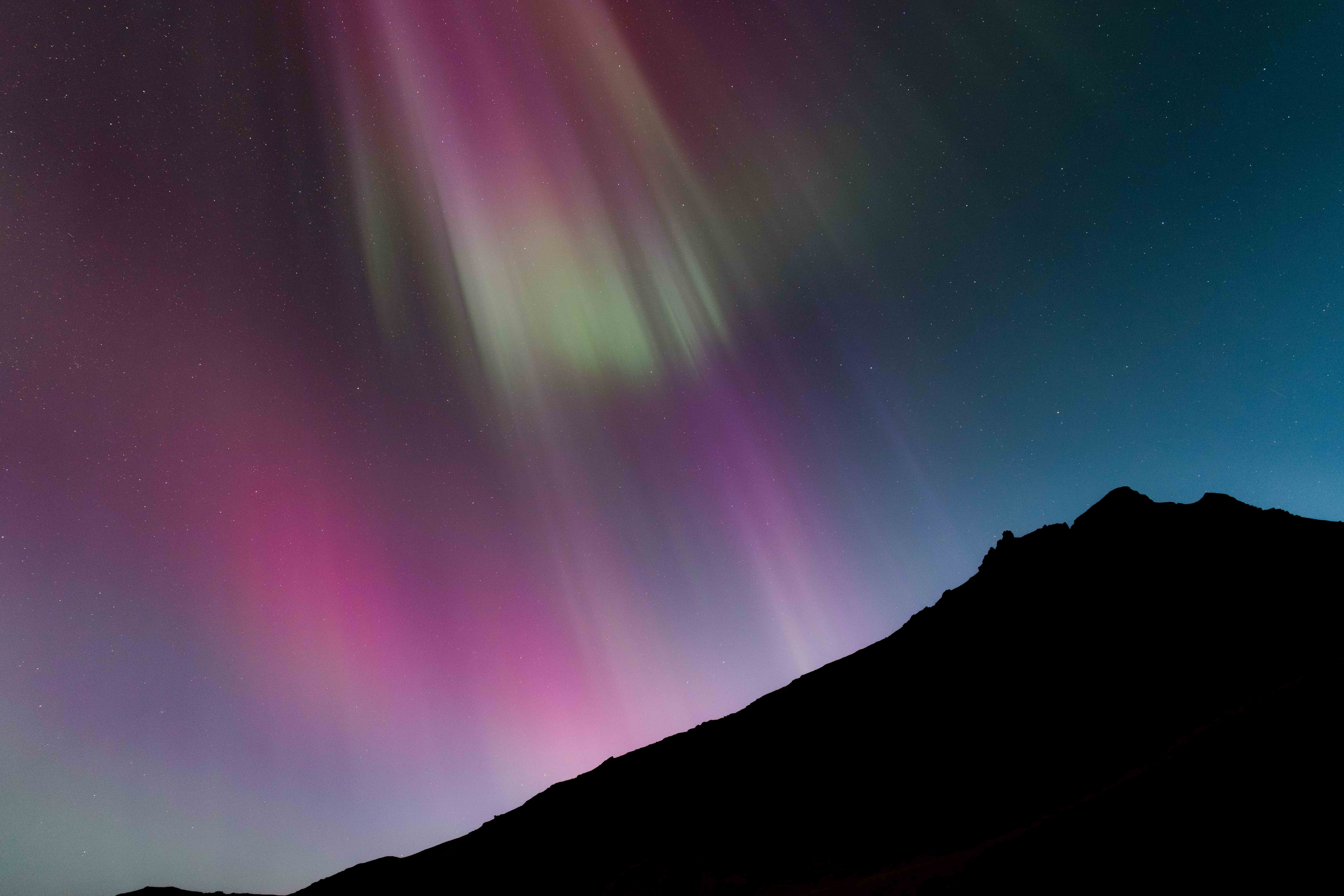 The Aurora Borealis above a mountain